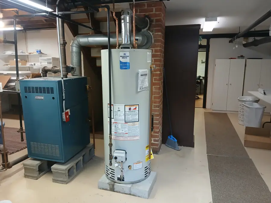 Gas water heater installed beside a boiler