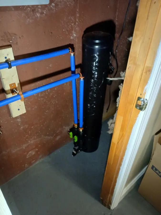 Water treatment tank with blue PEX piping